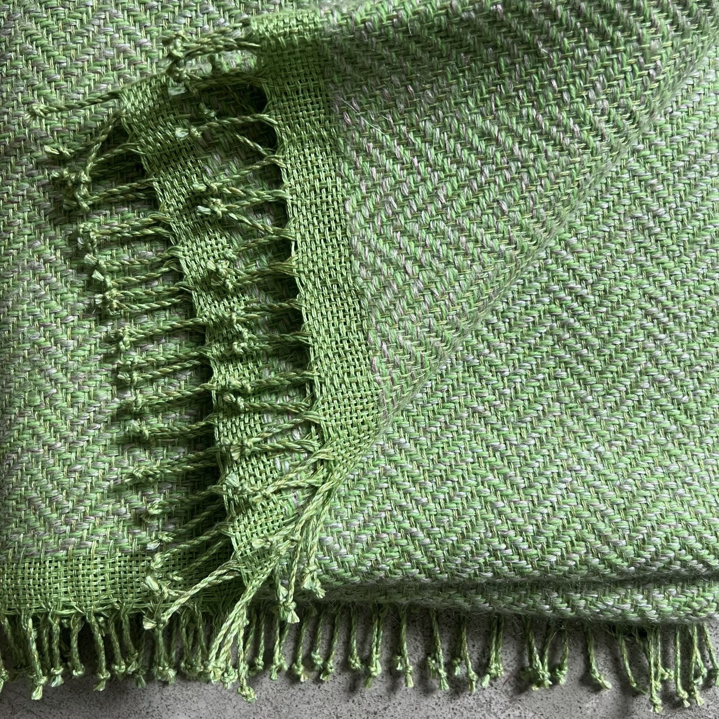Handwoven linen wool throw Trinis in lime green color with hand-twisted fringes 130x180 cm