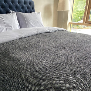 Boucle linen throw in black and natural color