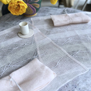 Handwoven linen napkin and placemat gift set in powder pink, that consists of 1 napkin 50x50 cm, 1 embroidered placemat 50x50 cm, and 1 silk napkin holder