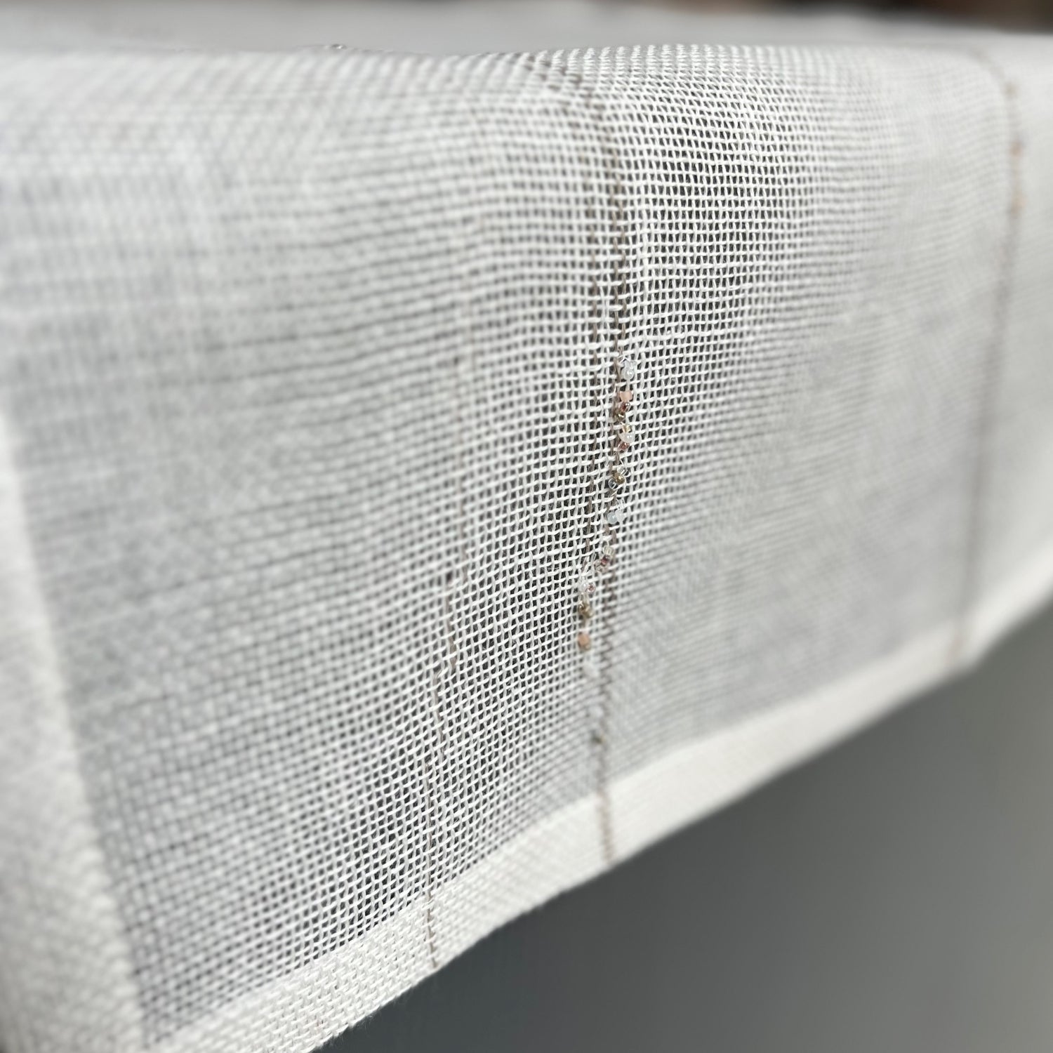 Handcrafted linen table runner in white color with natural lines and pearls 55x150 cm