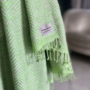 Handwoven linen wool throw Trinis in lime green color with hand-twisted fringes 130x180 cm