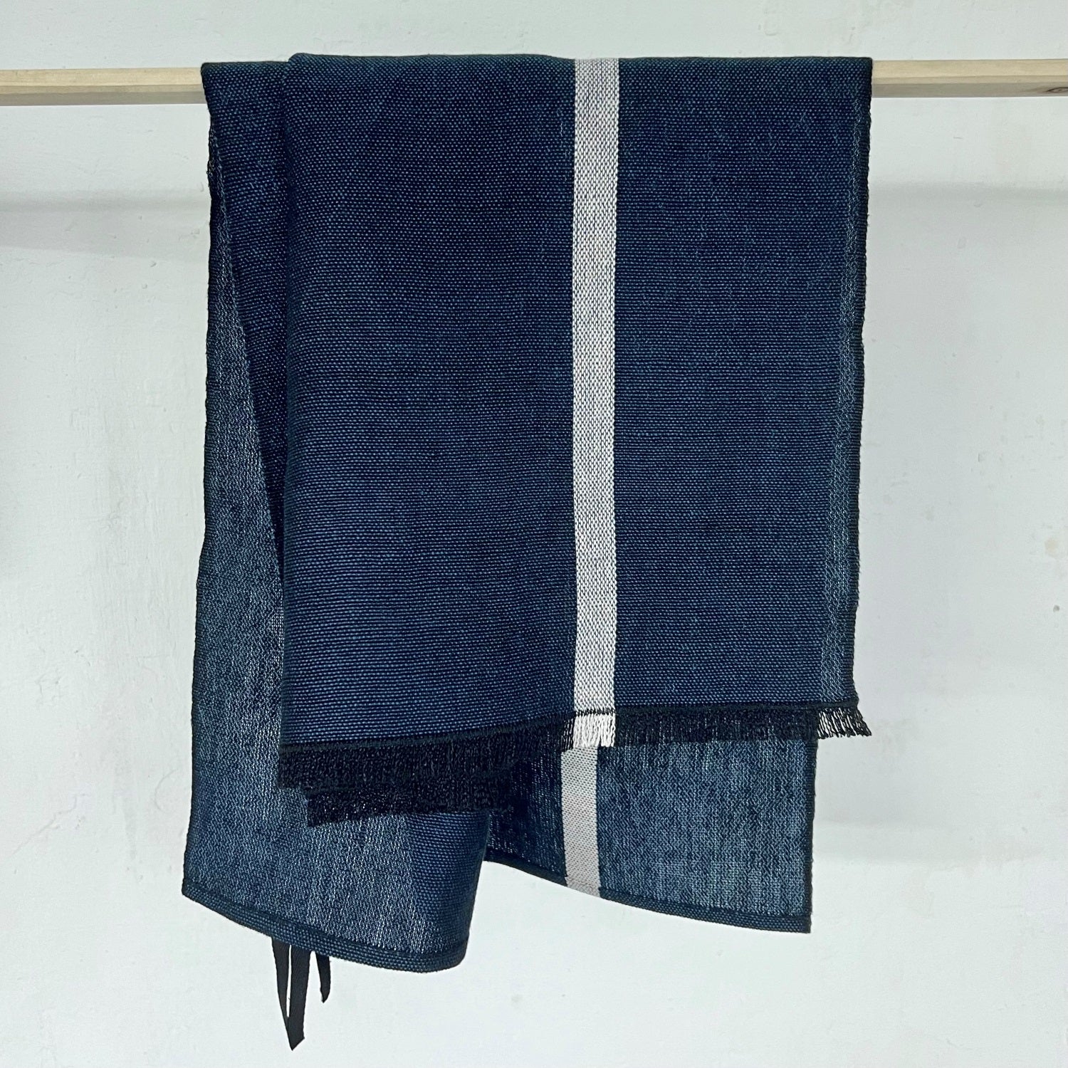 Handwoven linen kitchen towel in ocean blue 50x75 cm with small fringes on one side and decorative white line