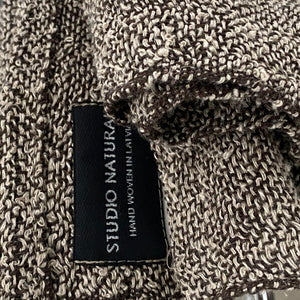 Handmade bouclé linen throw featuring looped linen thread texture in natural linen